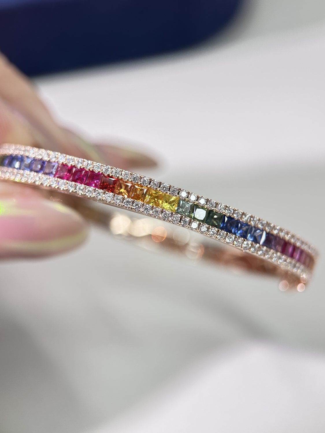 Rainbow sapphire bangle worn on wrist