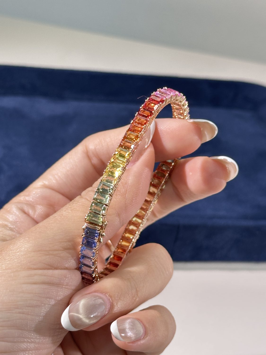 Rainbow sapphire bangle set worn on hand