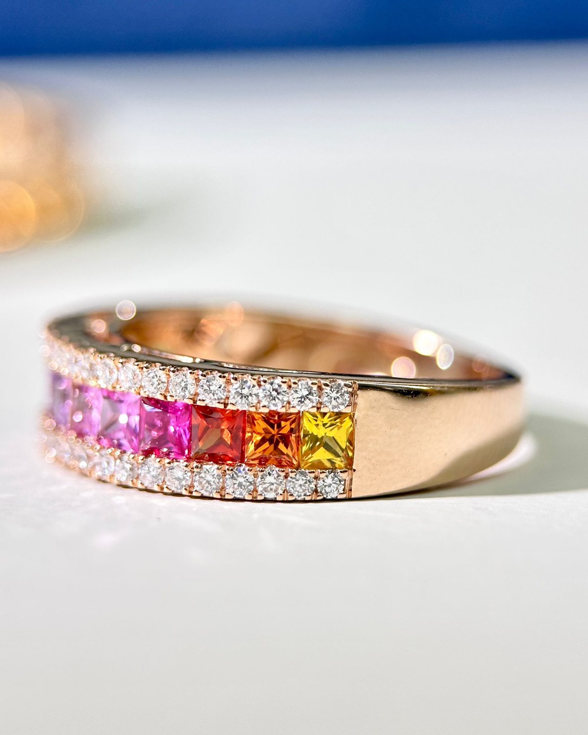 Rose gold rainbow sapphire eternity ring